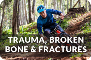 A young man rides down a steep forest trail on his bicycle. He is wearing a helmet and knee pads. Title reads: Trauma, Broken Bones, and Fractures