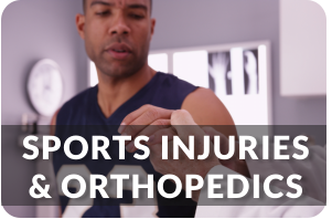 A young man in a sports jersey sits on an exam table as a doctor examines his injured hand. Title reads; Sports Injuries and Orthopedics